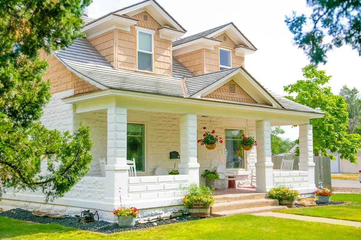 Wraparound porch on a yellow timber house