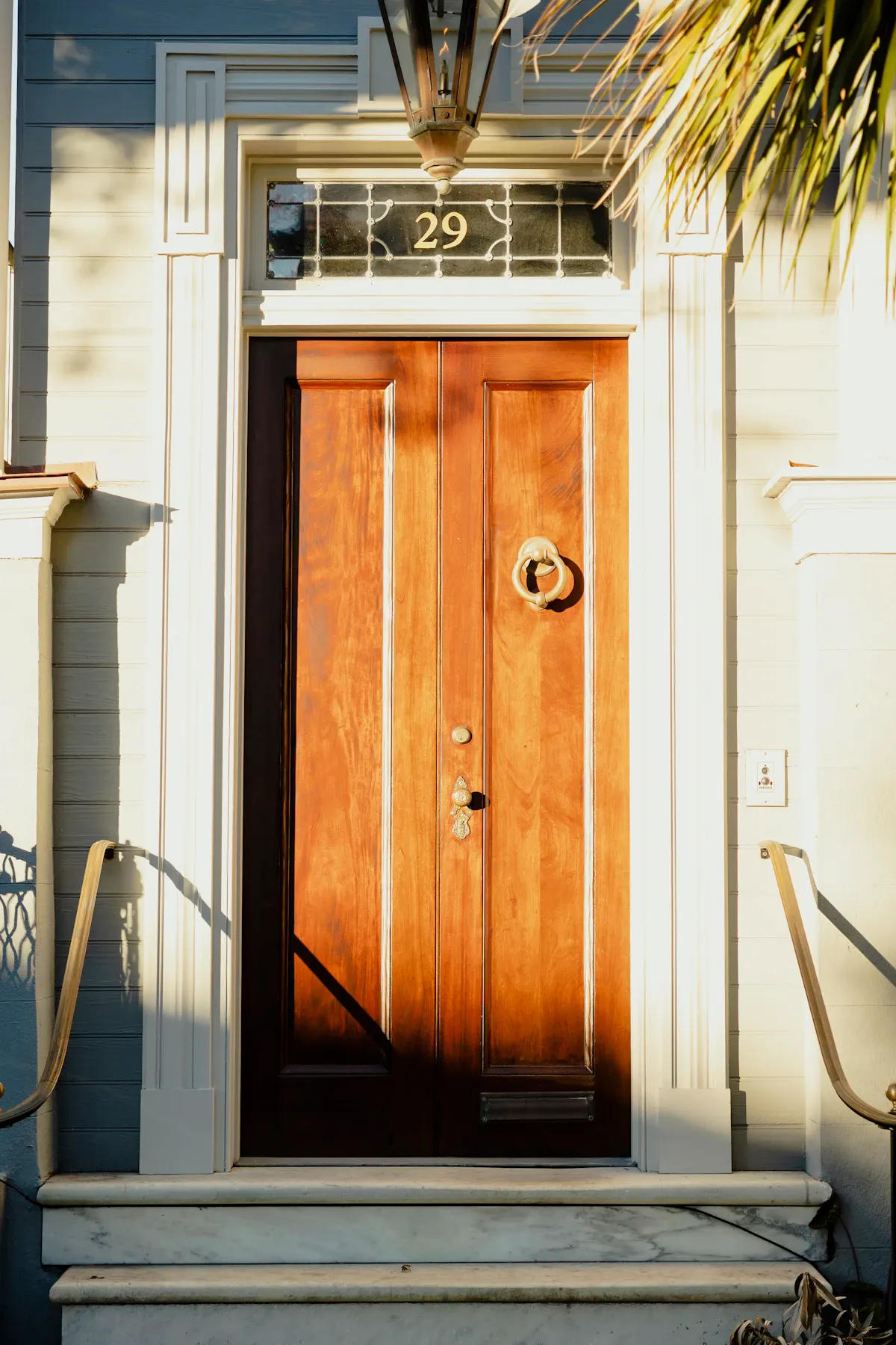 Timber entrance door framed by a small covered porch