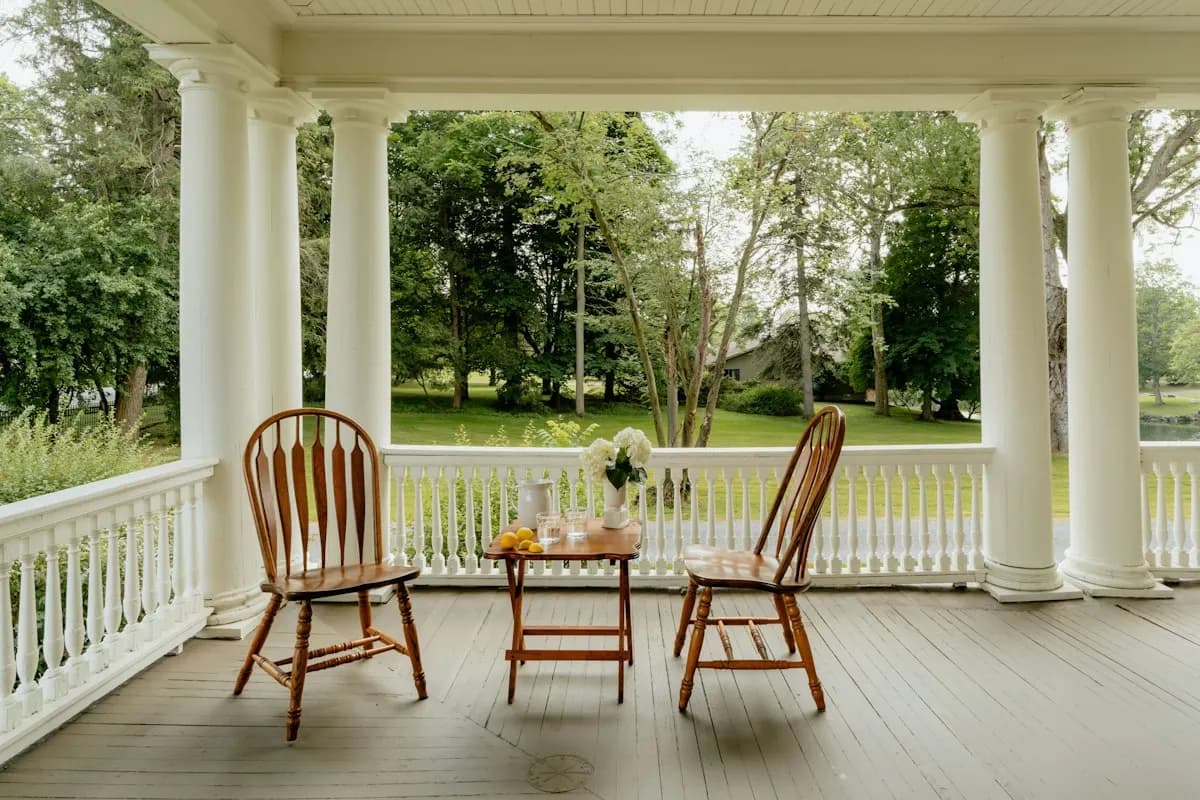 Covered white porch with rocking chairs