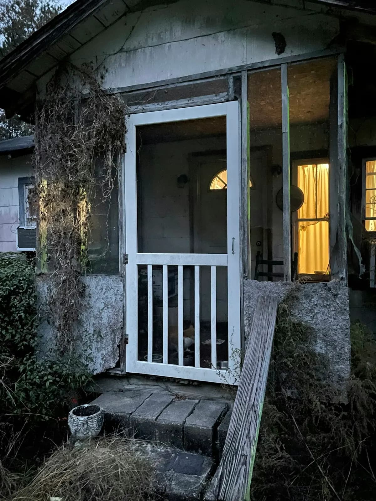 Small stone-house entry porch with timber steps