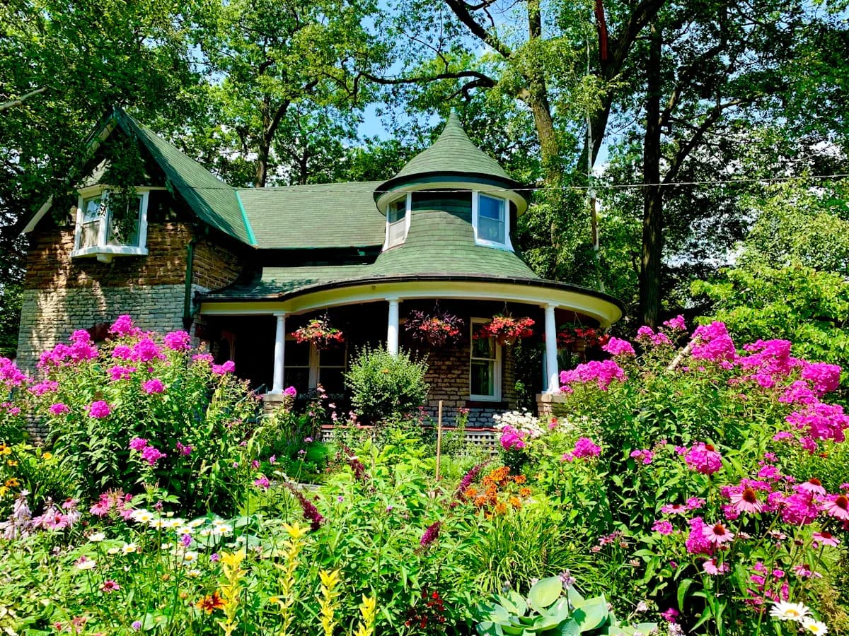 Covered garden porch surrounded by flowering shrubs