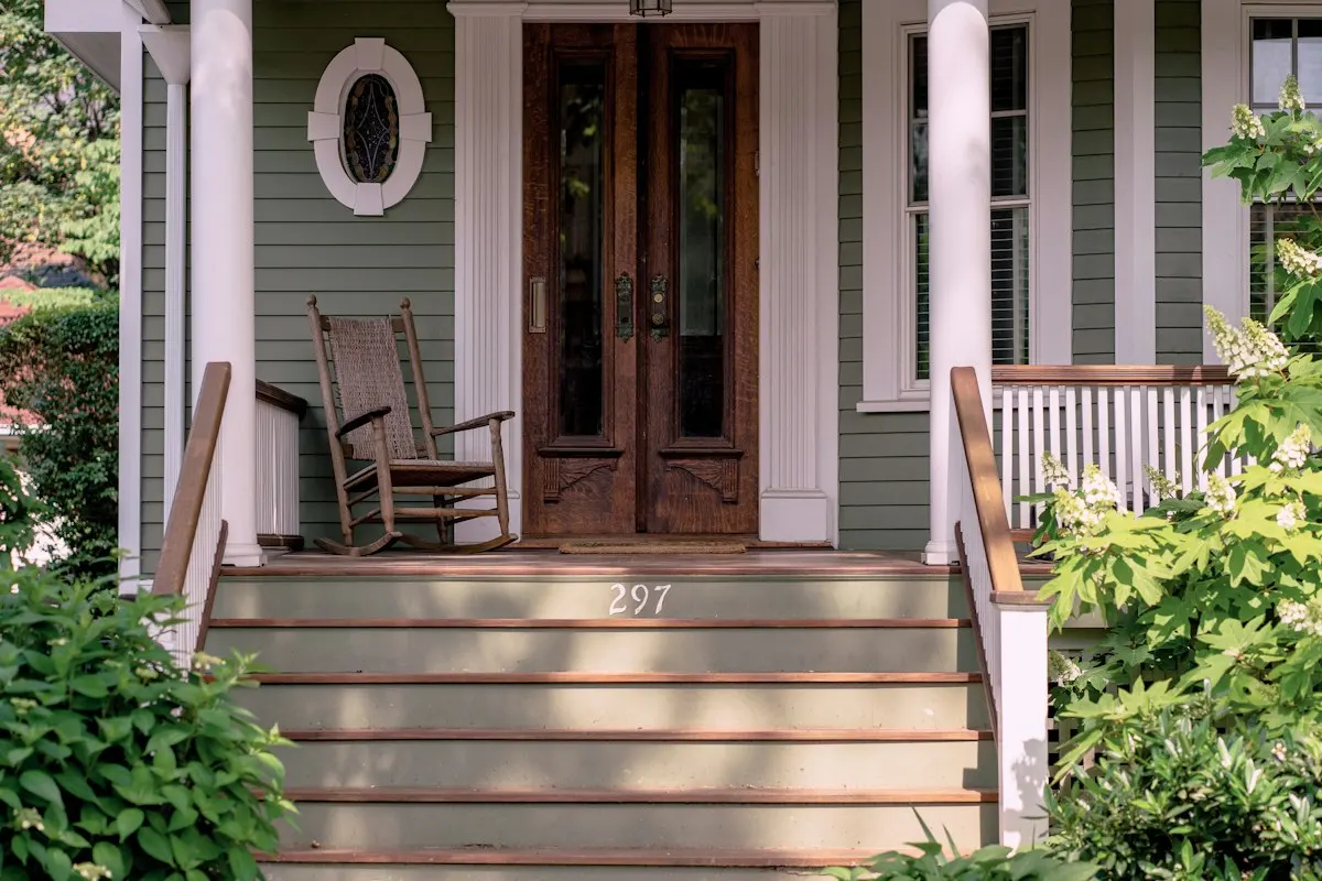Front porch with timber steps, columns and chairs