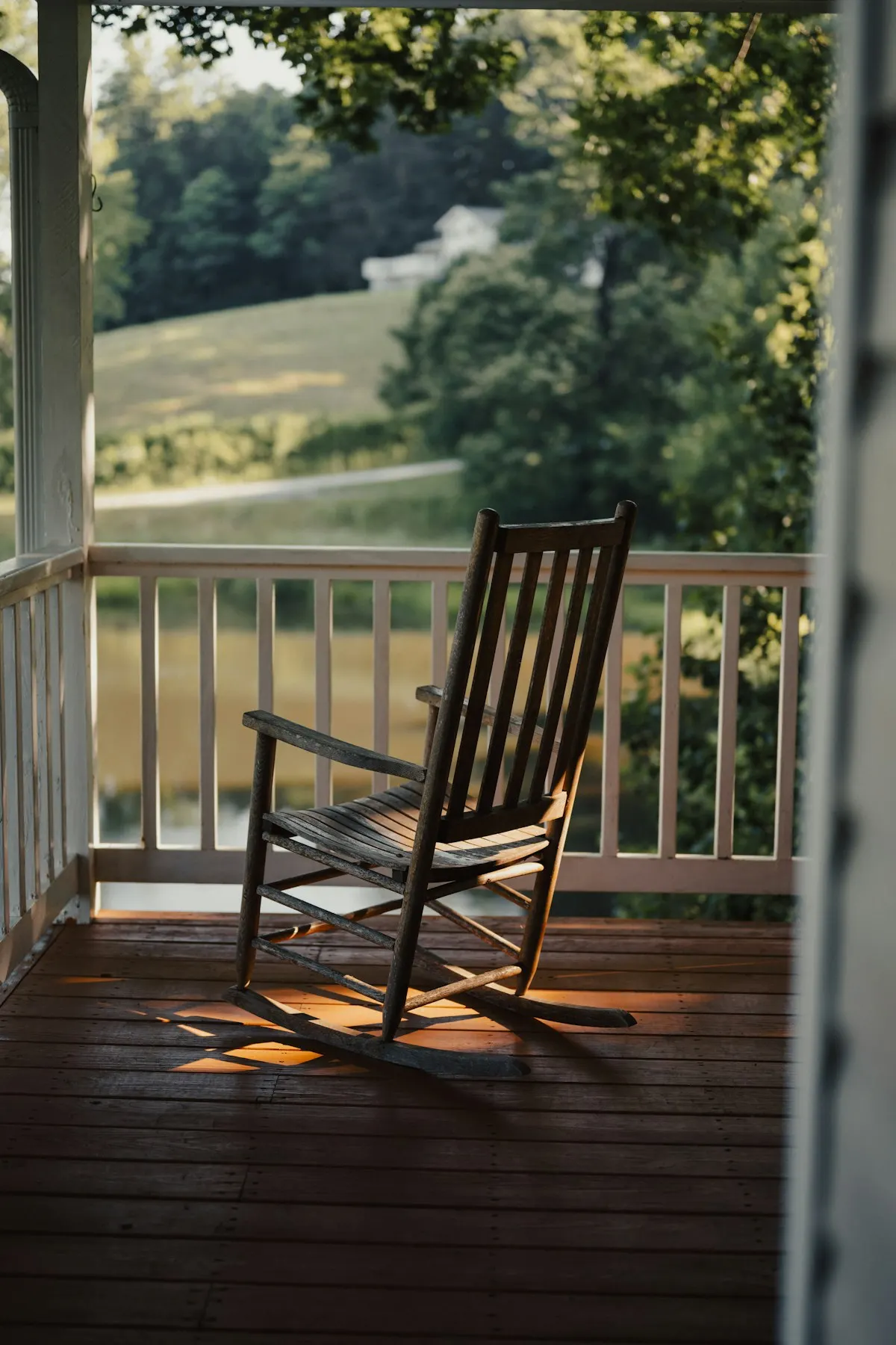 Rocking chair overlooking a garden from a porch
