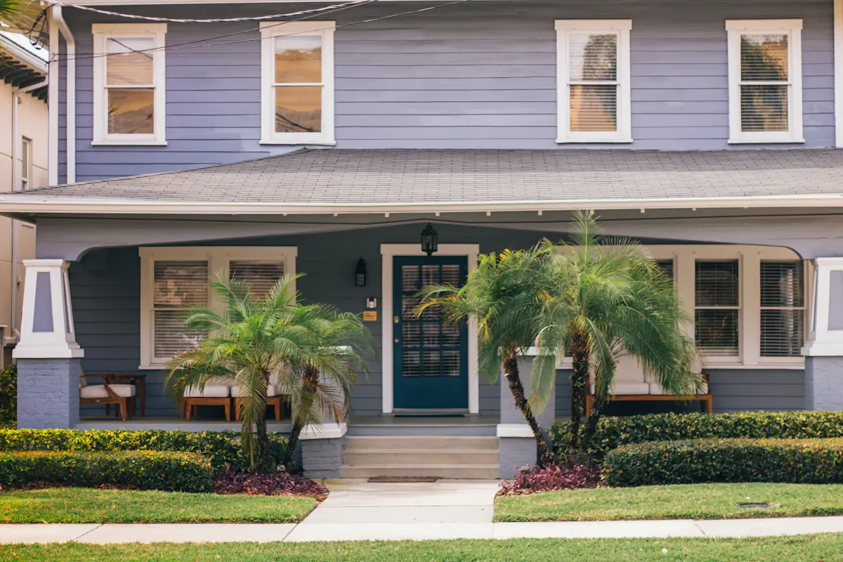 Broad covered porch across the front of a blue house