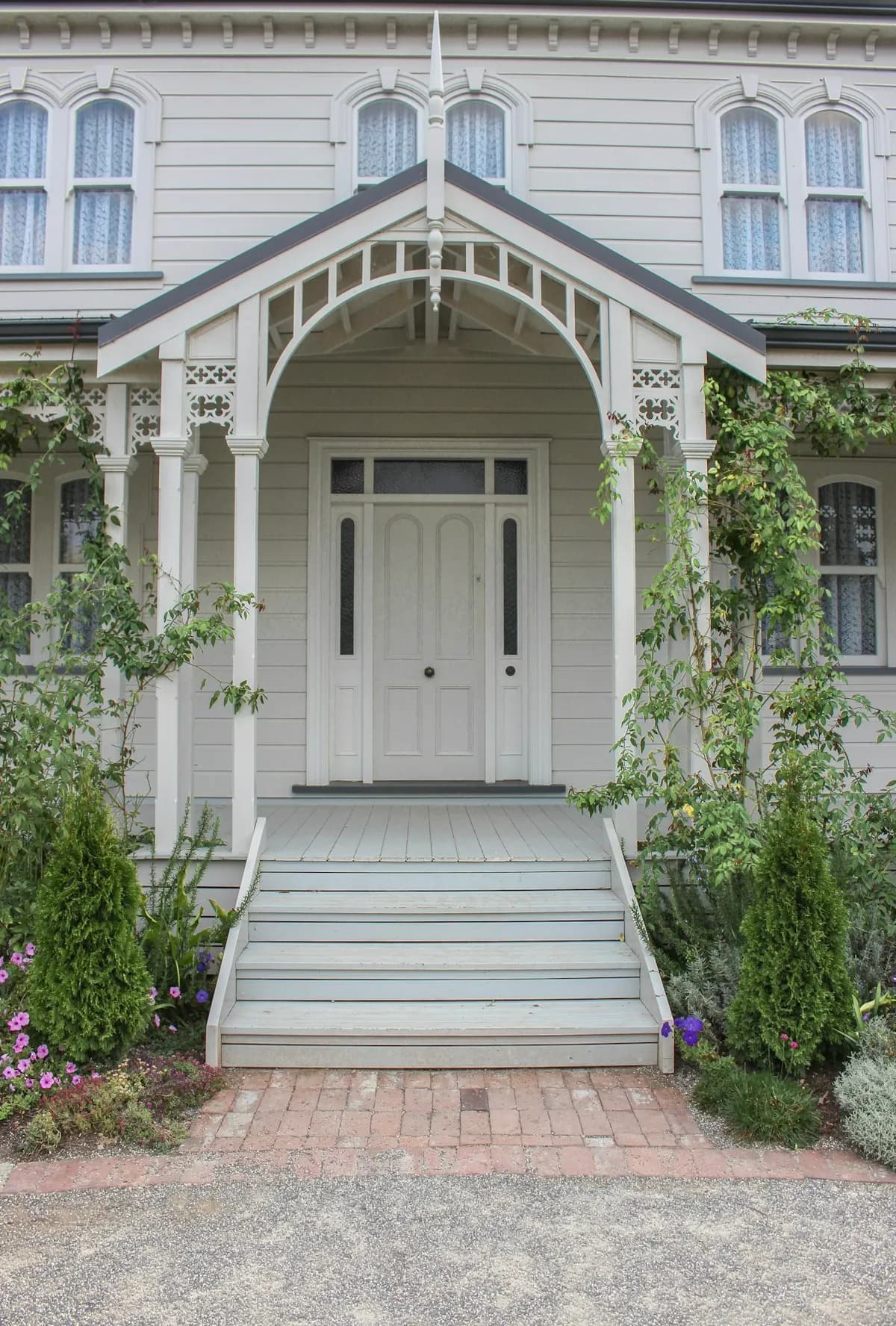 Small gabled entry porch with steps and timber trim
