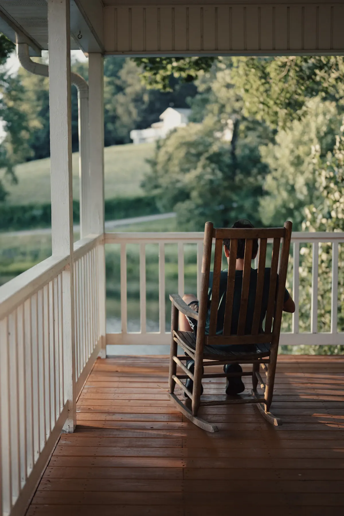 Timber porch with a railing and rocking chair