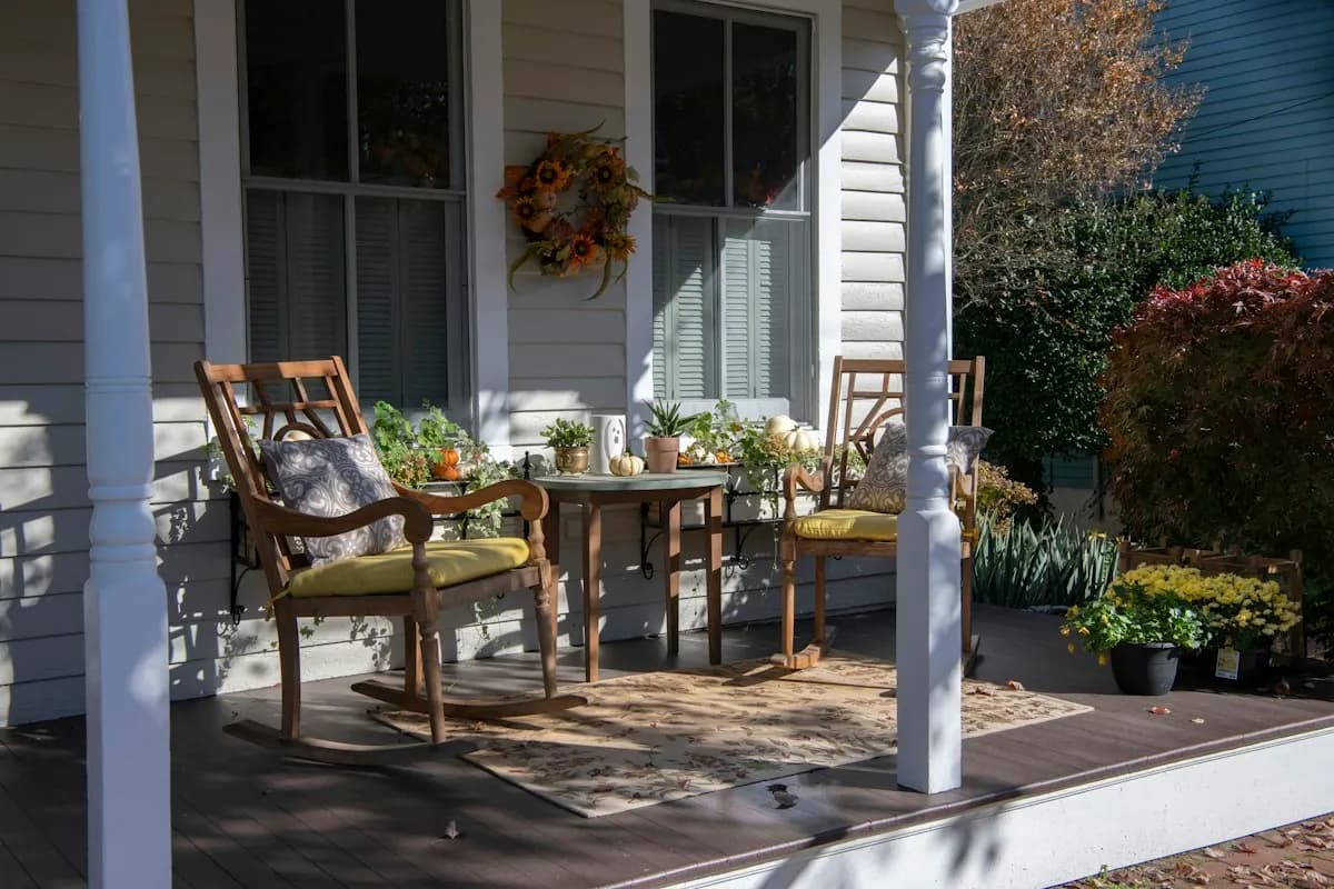 Porch dining table beside a house entrance