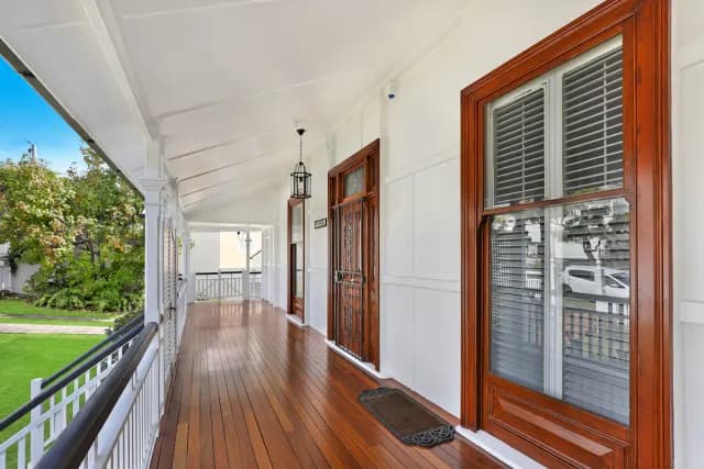 Long covered porch with polished timber boards