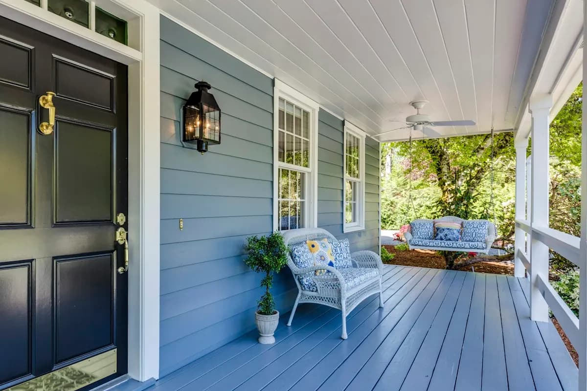 Blue covered front porch with outdoor seating