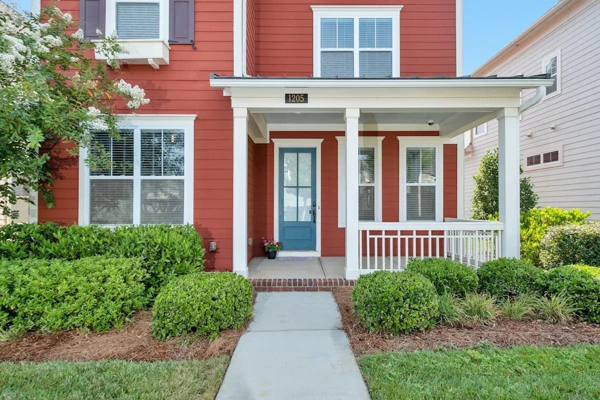 Covered porch and entrance path at a red house