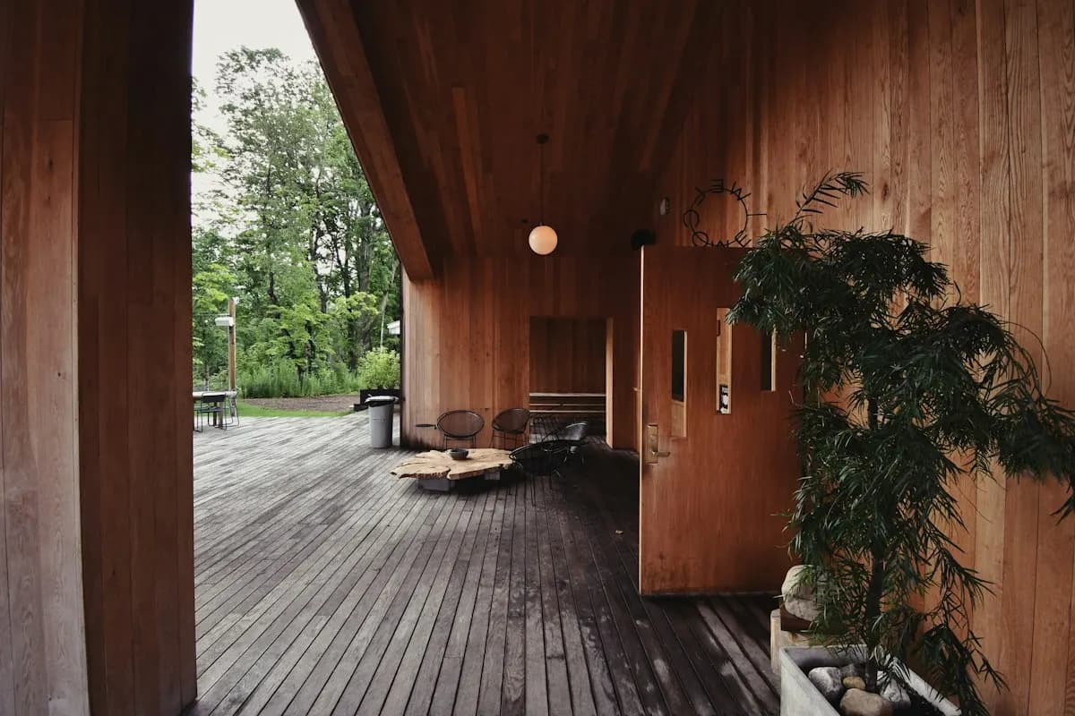 Deep timber-lined covered porch beside a garden